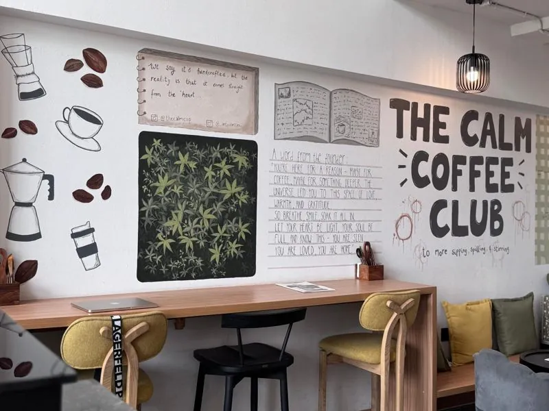 The Calm Coffee Club wall and work tables