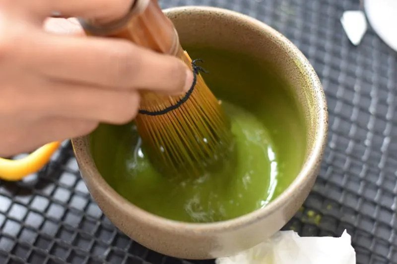 Matcha being whisked by hand