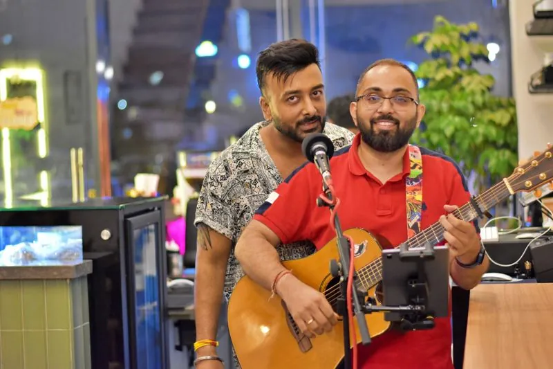 Two musicians performing at a Calm Cup music evening