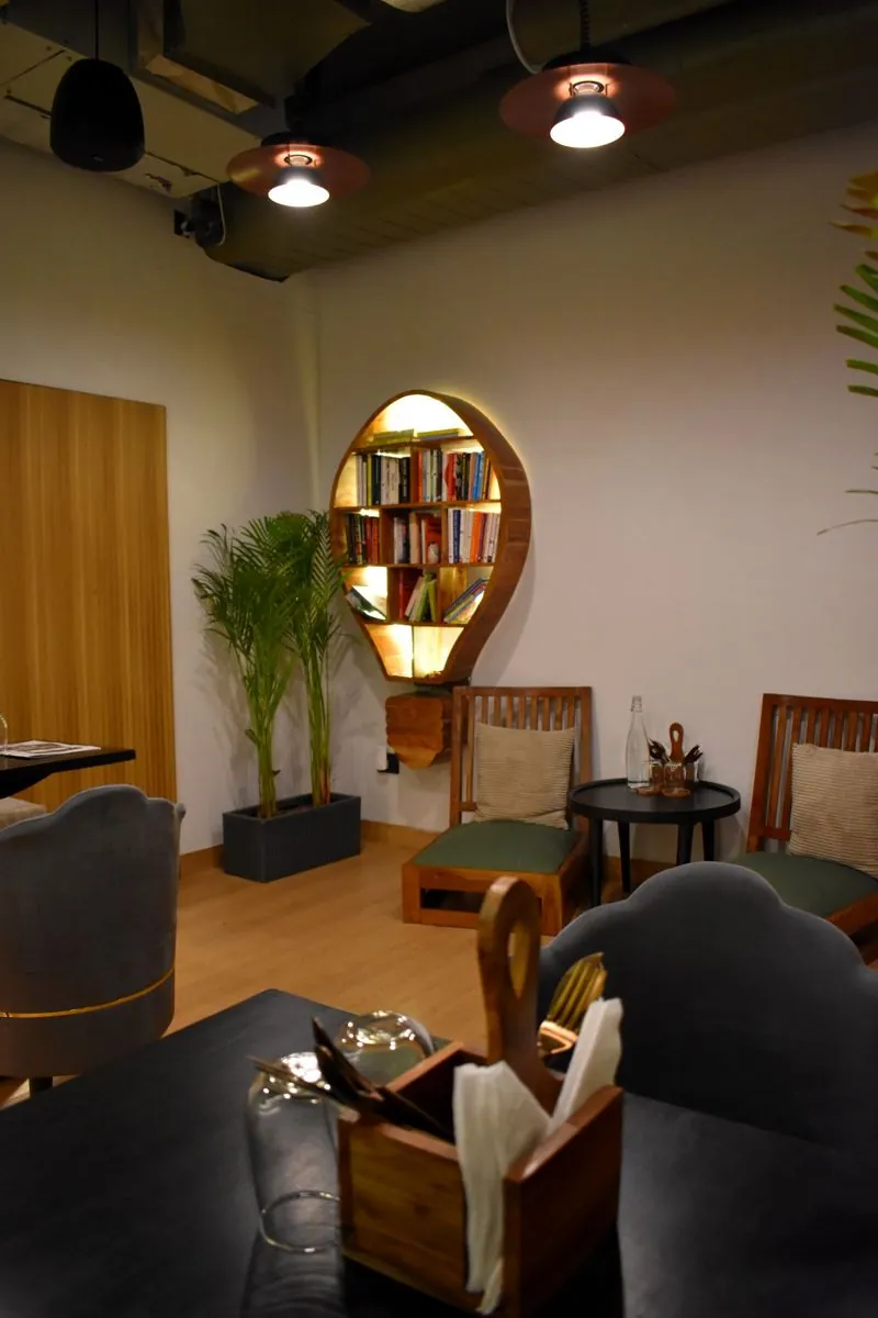 The reading corner with its round bookshelf at The Calm Cup